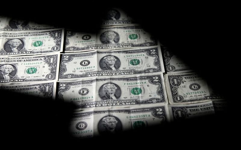 Dollar gains, on course for second monthly loss