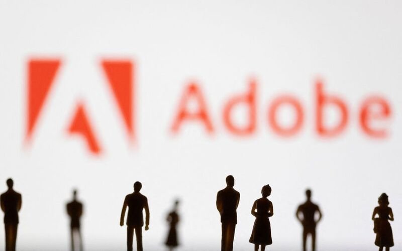 EU antitrust regulators set Aug. 7 deadline for Adobe-Figma merger. Figurines are seen in front of displayed Adobe logo in this illustration taken June 13, 2022. REUTERS/Dado Ruvic/Illustration