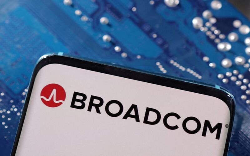 A smartphone with a displayed Broadcom logo is placed on a computer motherboard in this illustration