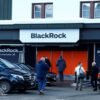 People are seen in front of a showroom that hosts BlackRock in Davos