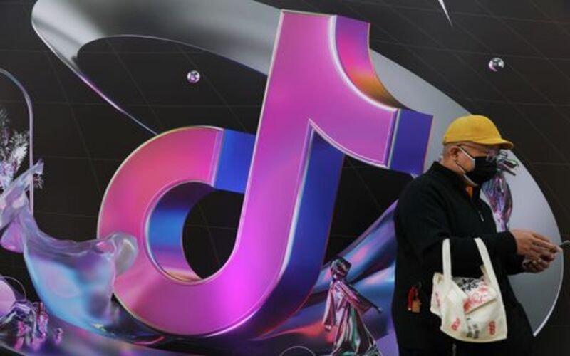 TikTok won’t launch cross-border e-commerce in Indonesia over worries. A man stands near a giant sign of Chinese company ByteDance's app TikTok, known locally as Douyin, during China Fashion Week, in Beijing, China March 31, 2021. REUTERS/Tingshu Wang/