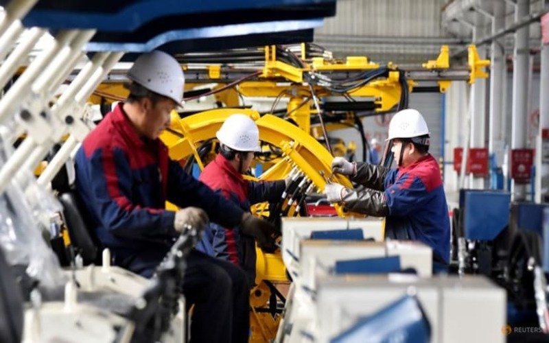 Employees work on a drilling machine production line at a factory in Zhangjiakou, Hebei province, China