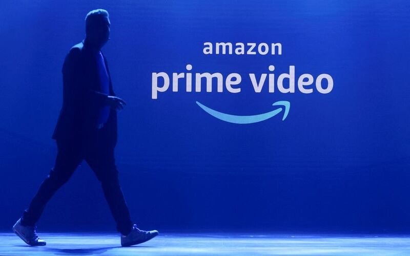 Amazon will roll out ads on Prime Video in 2024 A man walks past a logo of Amazon Prime Video during a launch event in Mumbai, India, April 28, 2022. REUTERS/Francis Mascarenhas/File Photo