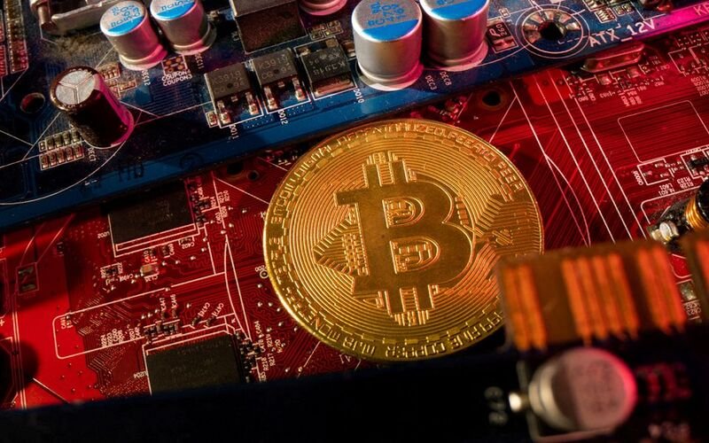 A representation of cryptocurrency Bitcoin is placed on a PC motherboard, in this illustration