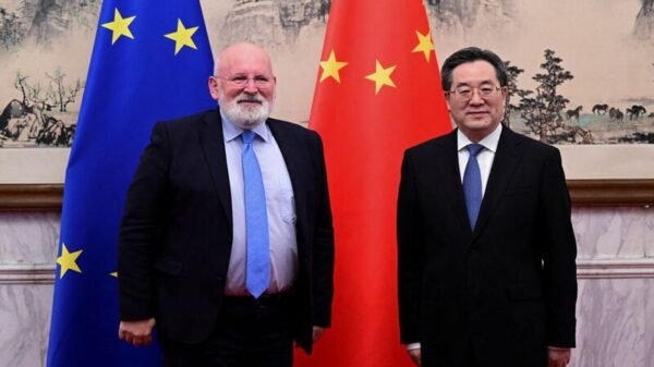 European Commission Executive Vice President Frans Timmermans (L) and China's Vice Premier Ding Xuexiang pose for pictures during a meeting at the Diaoyutai State Guesthouse