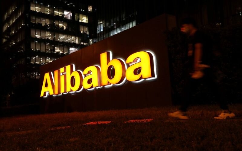 Alibaba promises major discounts ahead of China’s ‘Singles Day’ shopping event A man walks past a logo of Alibaba Group at its office building in Beijing, China August 9, 2021. REUTERS/Tingshu Wang