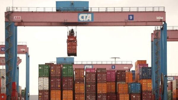 A crane lifts a shipping container at the HHLA Container Terminal Altenwerder on the River Elbe in Hamburg, Germany