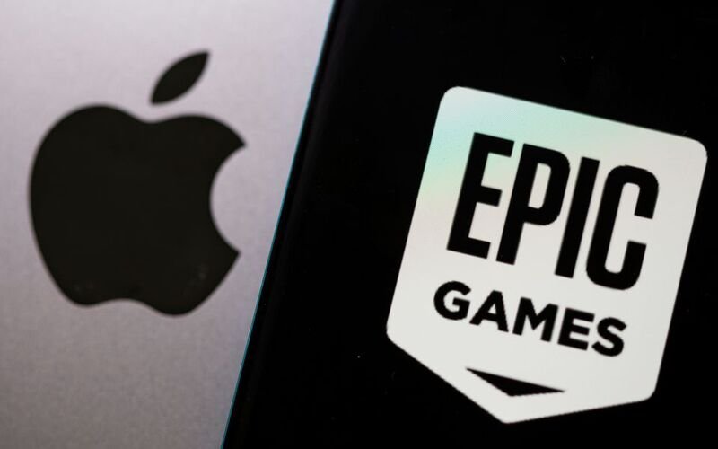 Epic Games is laying off roughly 900 employees Smartphone with Epic Games logo is seen in front of Apple logo in this illustration taken, May 2, 2021. REUTERS/Dado Ruvic/Illustration