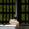 An investor watches a board showing stock information at a brokerage office in Beijing, China October 8, 2018. REUTERS/Jason Lee/File Photo