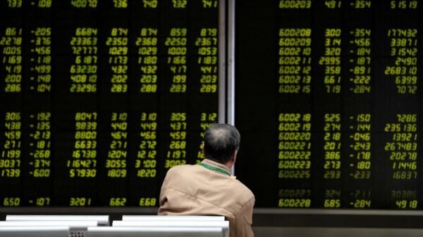 An investor watches a board showing stock information at a brokerage office in Beijing, China October 8, 2018. REUTERS/Jason Lee/File Photo