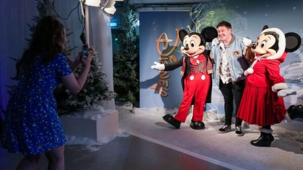 People take photos at Disney's product showcase during Magical Christmas Market