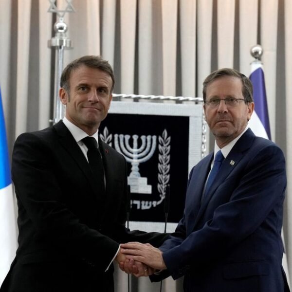 French President Emmanuel Macron, left, shakes hands with Israel's President Isaac Herzog in Jerusalem, Tuesday, Oct. 24, 2023. Emmanuel Macron is traveling to Israel to show France's solidarity with the country and further work on the release of hostages who are being held in Gaza. Christophe Ena/Pool via REUTERS