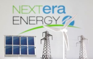 Miniatures of windmill, solar panel and electric pole are seen in front of NextEra Energy logo in this illustration taken January 17, 2023. REUTERS/Dado Ruvic/Illustration/File Photo