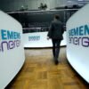 A trader walks next to Siemens Energy AG logos during Siemens Energy's initial public offering (IPO) at the Frankfurt Stock Exchange in Frankfurt, Germany, September 28, 2020. REUTERS/Ralph Orlowski/ File Photo