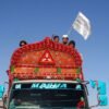 Afghan boys wave an Afghanistan flag as they board a truck while heading back with their family to Afghanistan from Pakistan, at the Chaman Border Crossing along the Pakistan-Afghanistan Border in Balochistan Province, in Chaman, Pakistan November 10, 2023. REUTERS/Naseer Ahmed/File Photo