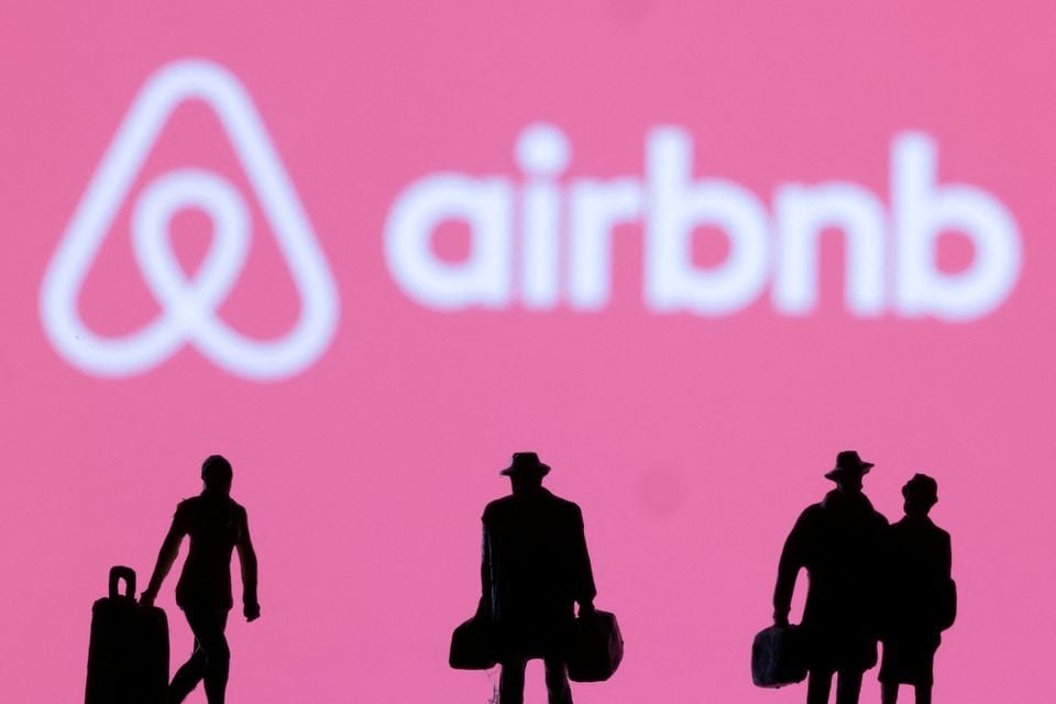 Figurines are seen in front of the Airbnb logo in this illustration taken February 27, 2022. REUTERS/Dado Ruvic/Illustration/File Photo