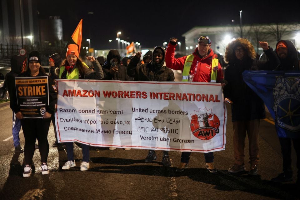 Amazon protests in Europe target warehouses and lockers on a busy Black Friday People hold a banner during a Black Friday strike outside the Amazon warehouse, in Coventry, Britain November 24, 2023. REUTERS/Phil Noble