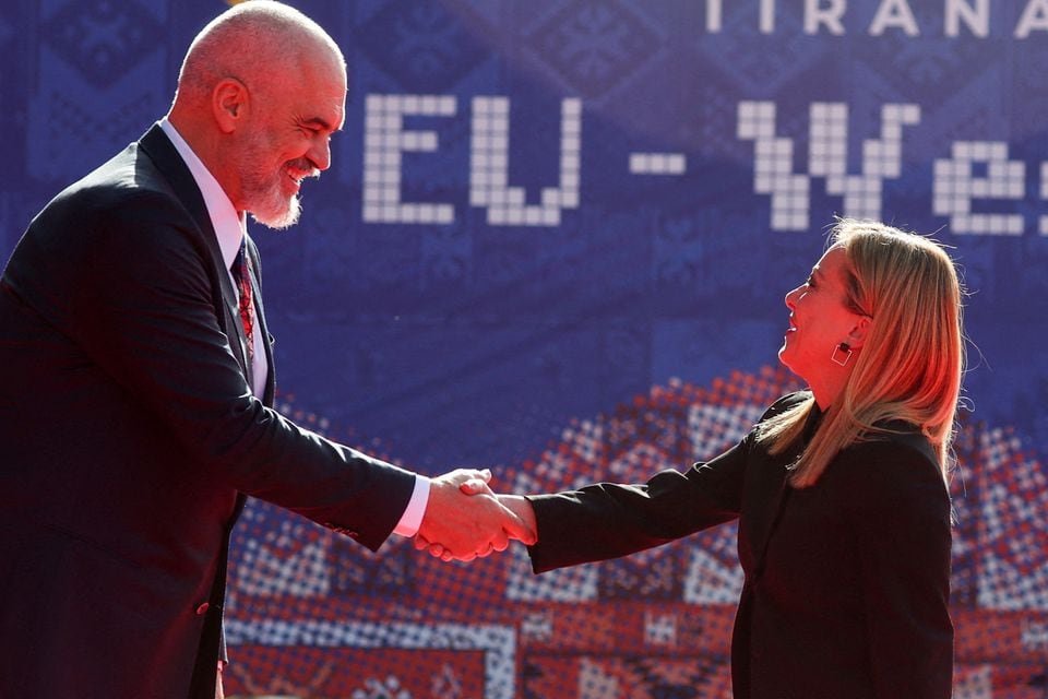 Italy says migrant pact with Albania isn’t comparable to UK-Rwanda plan Albania's Prime Minister Edi Rama welcomes Italy's Prime Minister Giorgia Meloni before the EU-Western Balkans summit in Tirana, Albania, December 6, 2022. REUTERS/Florion Goga/File Photo