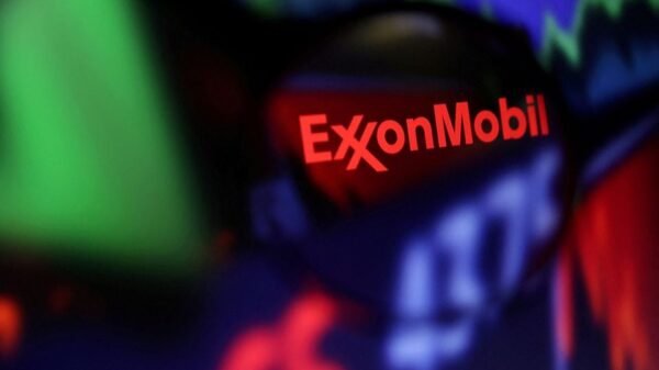 Exxon Mobil logo and stock graph are seen through a magnifier displayed in this illustration taken September 4, 2022. REUTERS/Dado Ruvic/Illustration/File Photo
