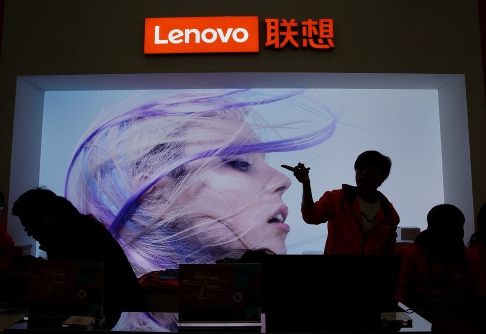 Lenovo posts another revenue decline as PC demand remains slow An employee gestures next to a Lenovo logo at Lenovo Tech World in Beijing, China November 15, 2019. REUTERS/Jason Lee/File Photo