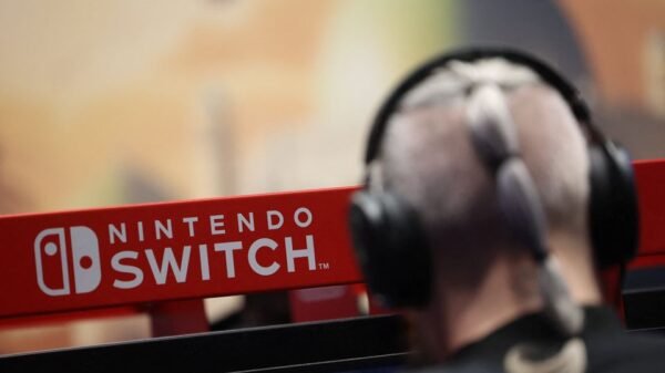 An attendee uses a Nintendo Switch game console while playing a video game at the Paris Games Week (PGW), a trade fair for video games in Paris, France, November 5, 2023. REUTERS/Claudia Greco/File Photo