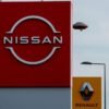 The logos of car manufacturers Renault and Nissan are seen in front of dealerships of the companies in Le Coteau, France, July 13, 2023. REUTERS/Gonzalo Fuentes/File Photo