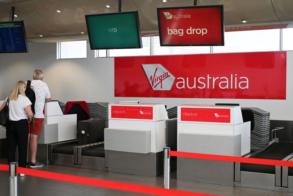 Virgin Australia adds Boeing MAX-8 aircraft as demand stays buoyant Travelers stand at a Virgin Australia Airlines counter at Kingsford Smith International Airport, in Sydney, Australia, March 18, 2020. REUTERS/Loren Elliott