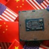 A central processing unit (CPU) semiconductor chip is displayed among flags of China and U.S., in this illustration picture taken February 17, 2023. REUTERS/Florence Lo/Illustration/File Photo