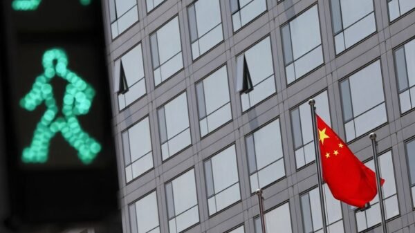 A Chinese national flag flutters outside the China Securities Regulatory Commission (CSRC) building on the Financial Street in Beijing, China July 9, 2021. REUTERS/Tingshu Wang/file photo