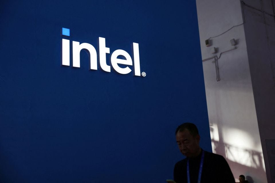 Intel says dozens of PC makers are using its new AI-enabled chip A man walks past the Intel logo at its booth during the first China International Supply Chain Expo (CISCE) in Beijing, China November 28, 2023. REUTERS/Florence Lo/File Photo