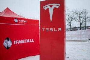 A IF metall tent stands next to a Tesla sign as workers picket outside of a Tesla service centre in Upplands Vasby, north of Stockholm, Sweden December 15, 2023. REUTERS/Marie Mannes