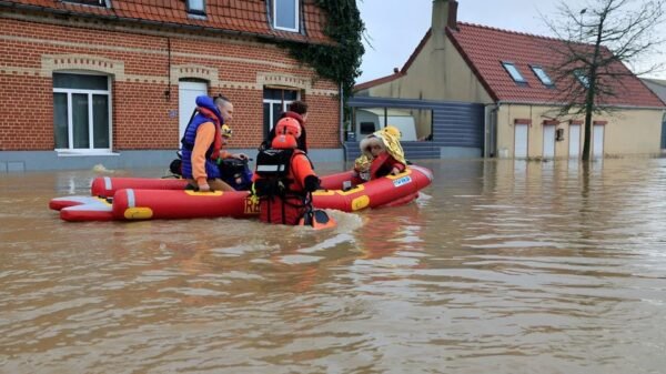 Members of French Civil Security rescue team evacuate local residents by boat as the Aa River overflows in Arques near Saint-Omer, after heavy rain caused flooding in northern France, January 3, 2024. REUTERS/Pascal Rossignol