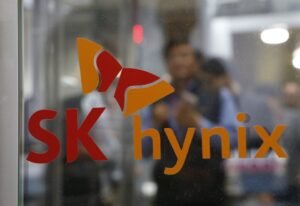 Employee walk past the logo of SK Hynix at its headquarters in Seongnam, South Korea, April 25, 2016. REUTERS/Kim Hong-Ji/File Photo