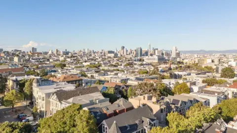 Open Homes Photography A view of San Francisco's skyline, with the skyscrapers of the city centre in the far distance