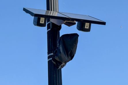 a plastic bag over a pole-mounted camera