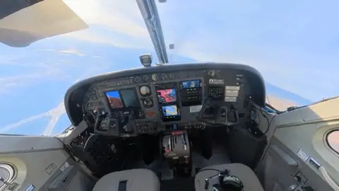 Reliable Robotics The cockpit of a flying plane with no pilots - just two empty seats.
