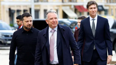 Reuters three men in suits walking outside.